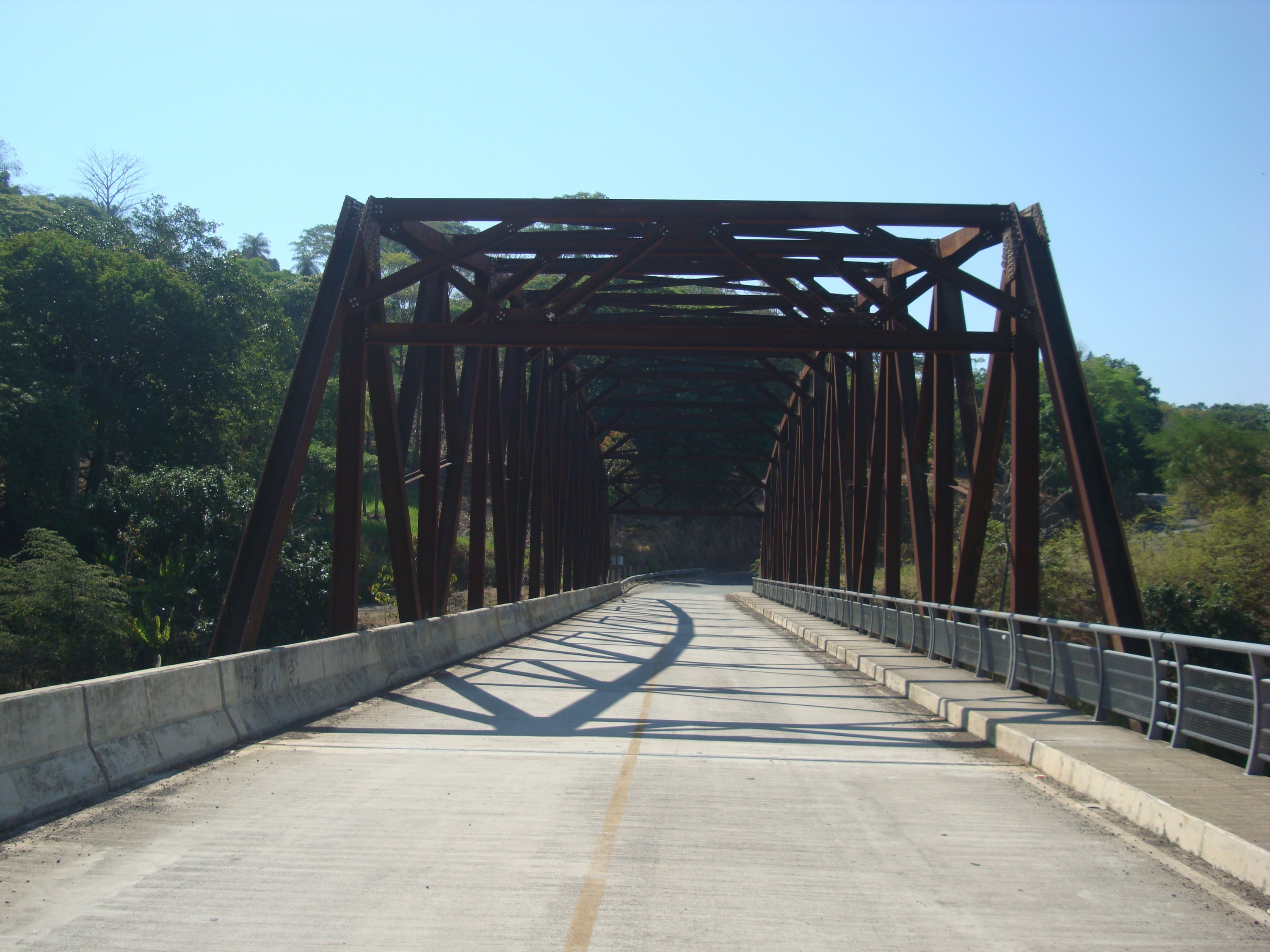Steel truss bridge seen from the roadway.