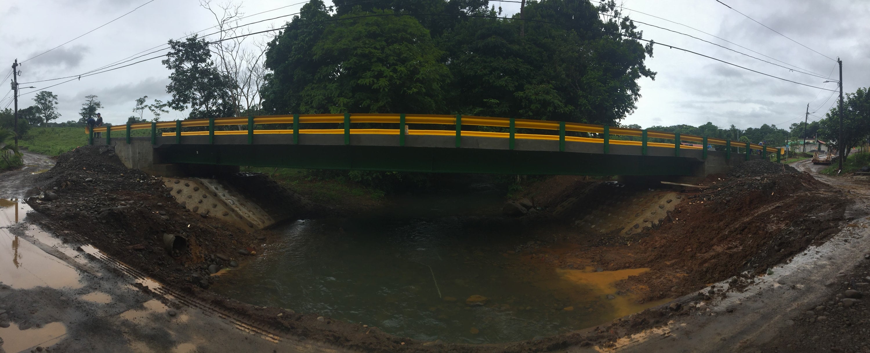 Steel-girder bridge with railings over a river.